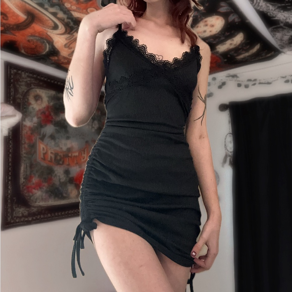 Black mini dress with lace trim and adjustable tie sides